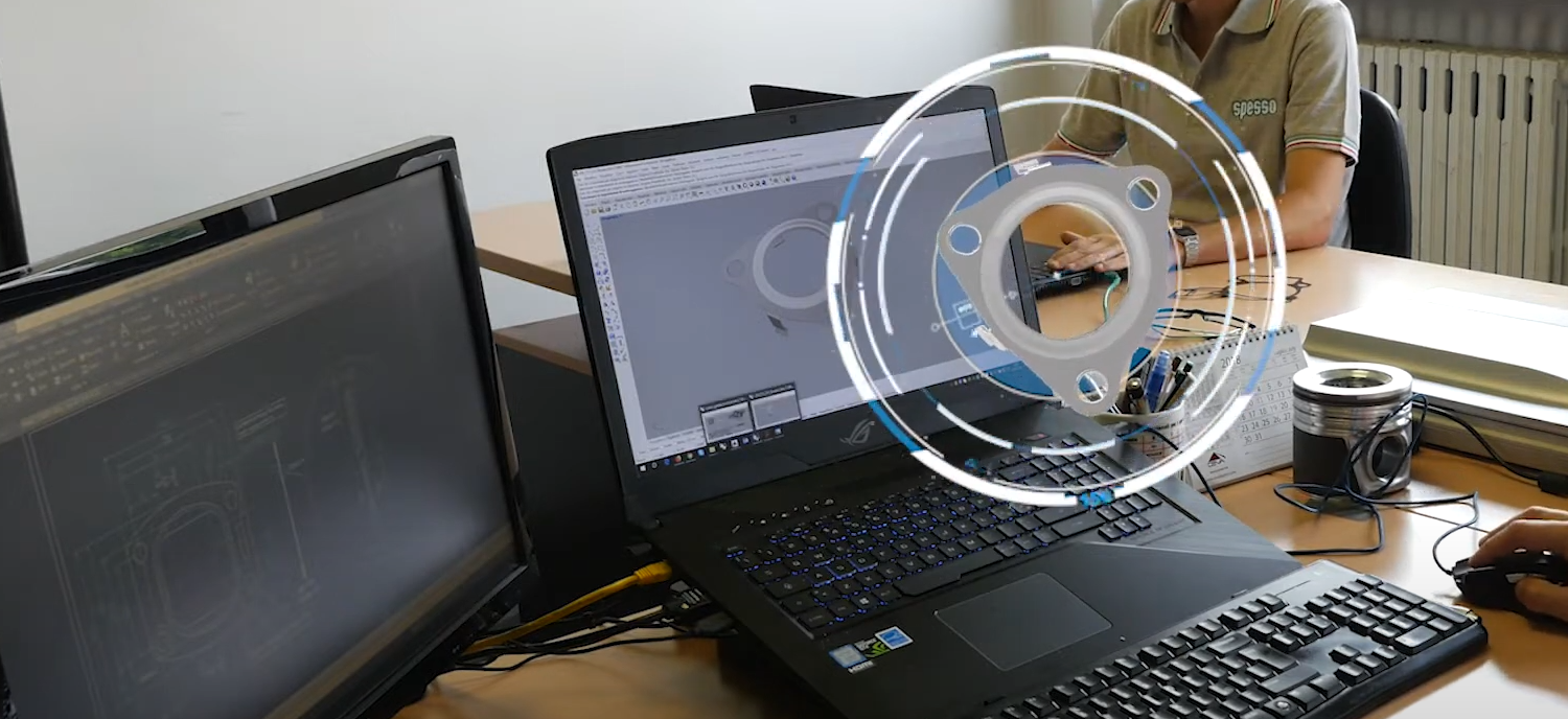 Engineer using CAD software to design engine gaskets on a PC